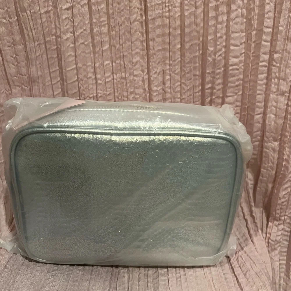 Victoria’s Secret silver snake skin purse with gold chain strap.